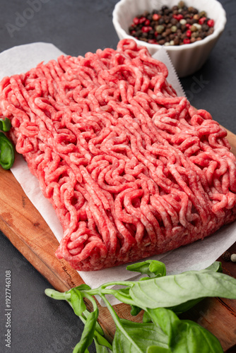 Raw ground meat on black stone table background