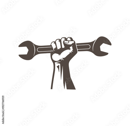 clenched fist holding adjustable wrench as symbol of power and maintenance