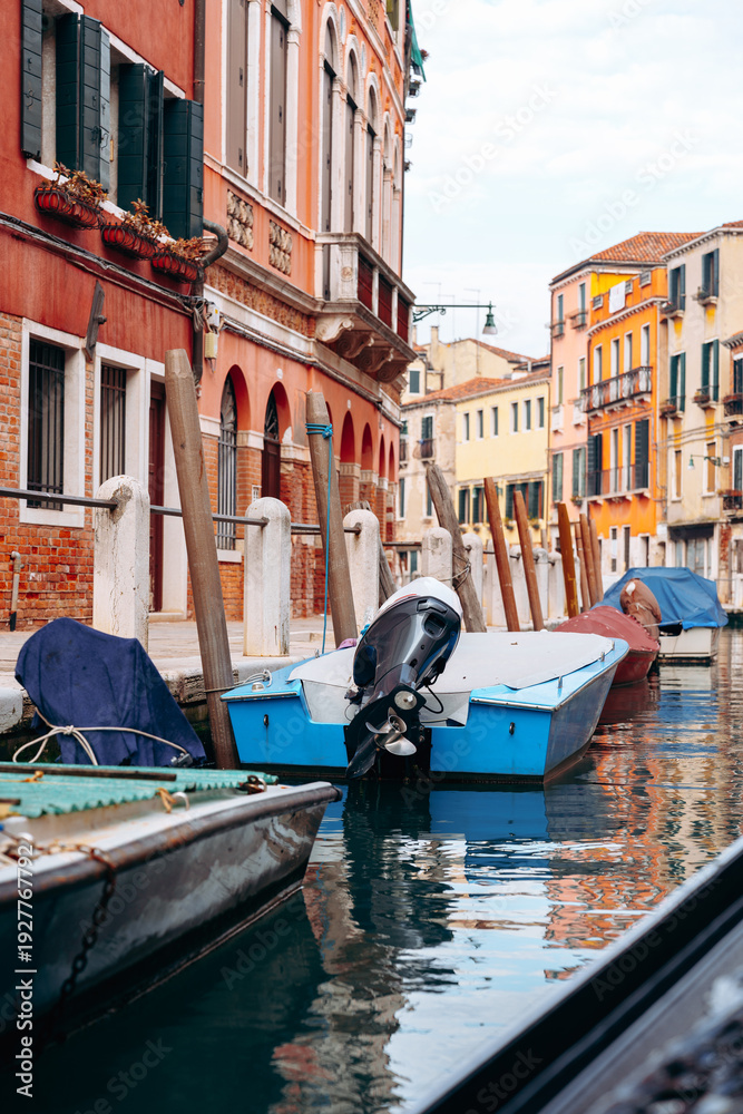 Fototapeta premium Boats rest in a quiet canal in a historic city on a clear sunny day