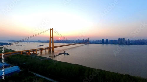 Stunning city timelapse footage capturing the transition from sunrise to sunset, with golden hour light, dramatic clouds, and city lights illuminating the urban skyline in 4K.