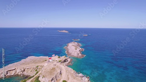 Drone Flight Over Apostle Andrew's Cape on Karpaz Peninsula with Turkish and Northern Cyprus Flags Waving Above Klydes Islets