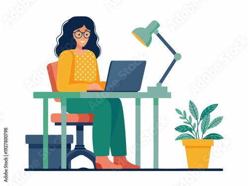 A young woman works on a laptop at a desk with a plant