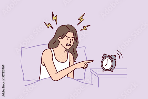 Tired woman wakes up irritated at 7 am from loud alarm clock under blanket. Young girl feels exhausted, annoyed, and lacks sleep after stressful night, struggling to get out of bed.