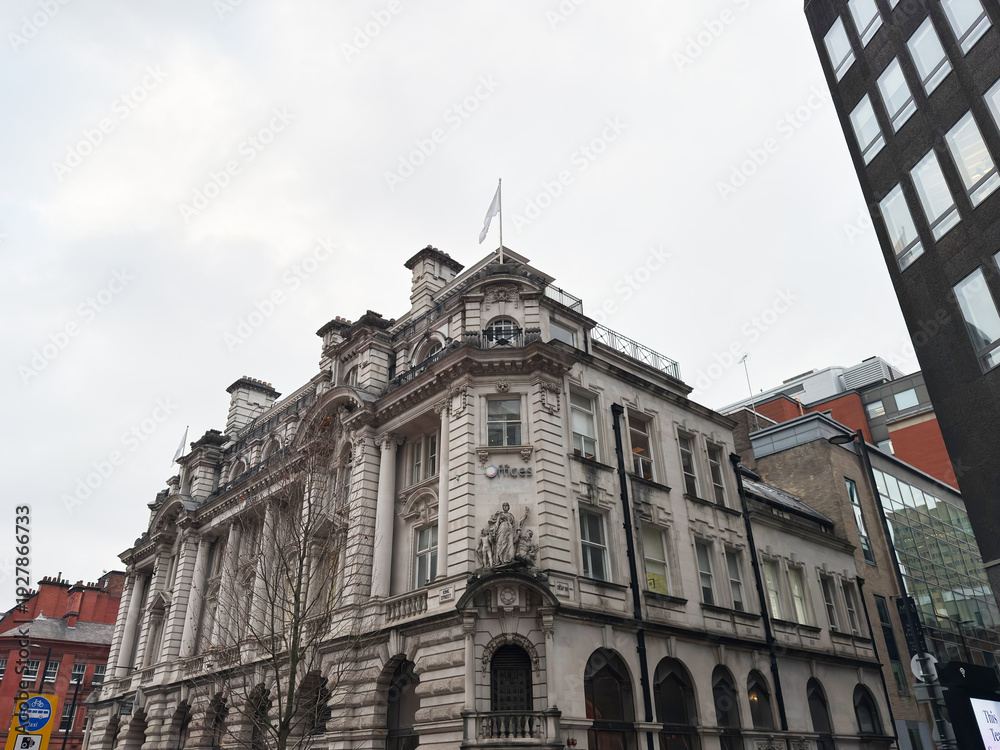 Obraz premium Historic white stone building in Manchester city centre with ornate architecture and arches