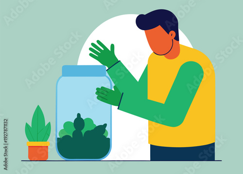 A person wearing green gloves carefully plants small green plants inside a glass jar with a potted plant nearby.