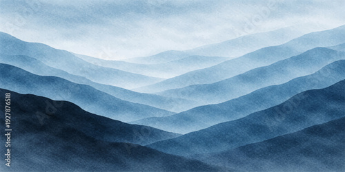 A misty morning view of the blue sky and clouds over a snow-covered mountain landscape at sunrise