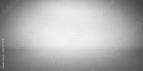 A brushed metal texture background featuring a shiny silver stainless steel plate pattern with light reflecting off a gray metallic aluminum surface backdrop for an empty industrial wall design