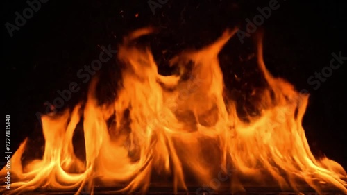 Vibrant orange flames dancing in darkness