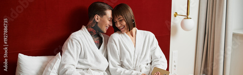 Young couple sharing a joyful moment in a cozy hotel room filled with love