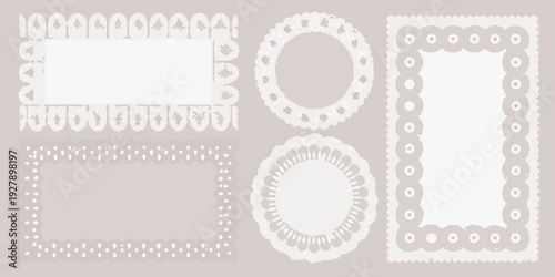 Various white decorative paper frames and borders with ornate details arranged on a light gray background
