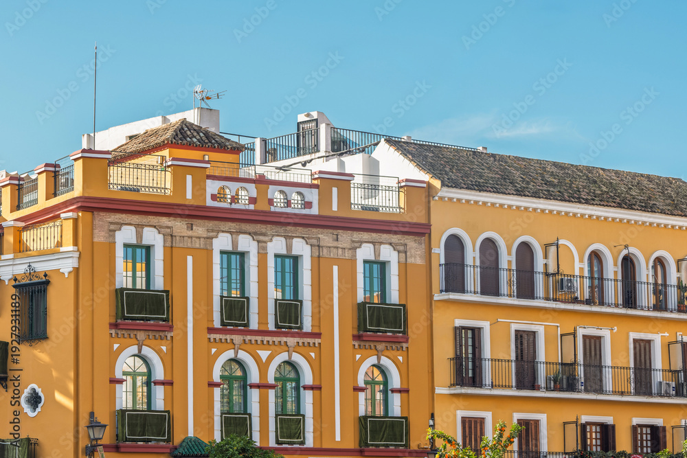 Fototapeta premium Traditional Yellow Facades and Balconies in the Macarena District, Seville, Spain