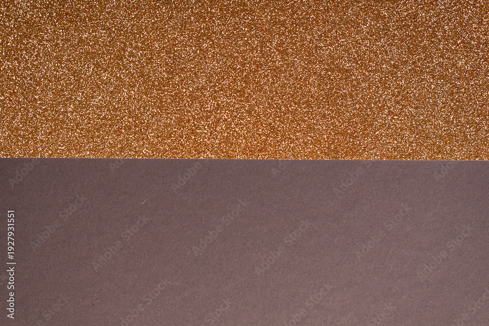 Fototapeta premium Abstract background featuring a sparkly gold glitter texture and a solid brown base. Perfect for design templates and ho
