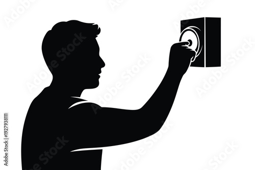 Silhouette of a man listening at a wall with a listening device