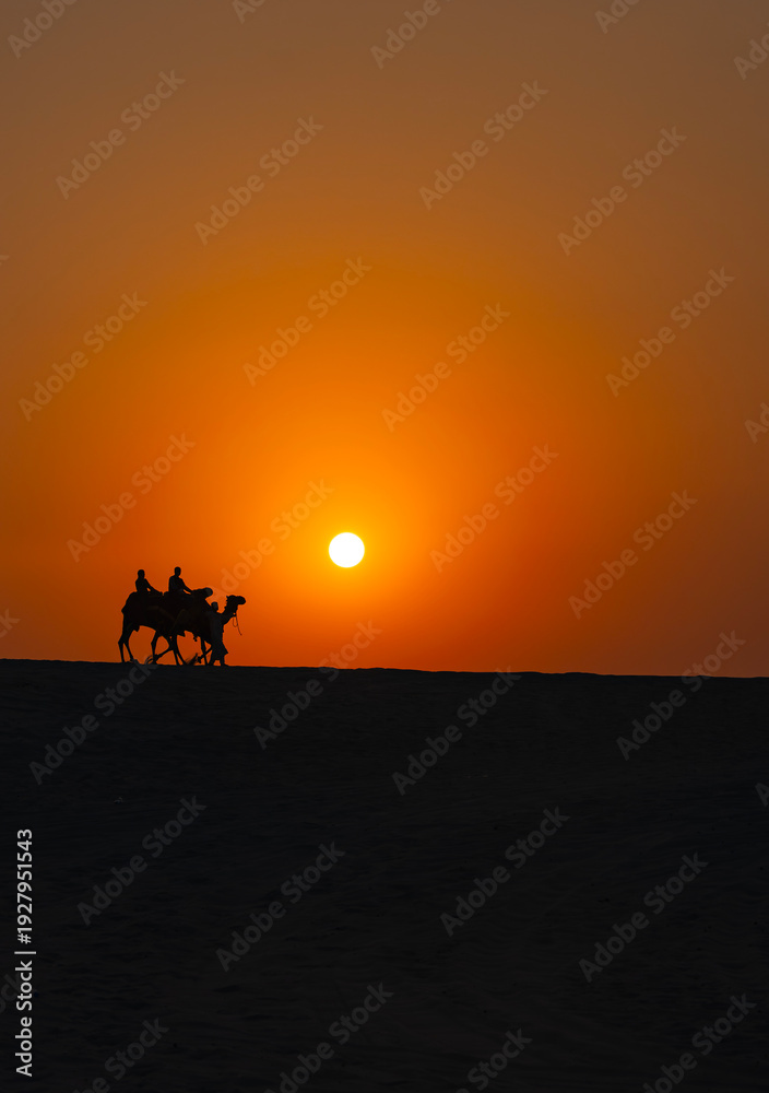 Fototapeta premium Ramadan Kareem Background Photo, Camel Caravan in the Sunset Time, Doha Desert, Doha Qatar