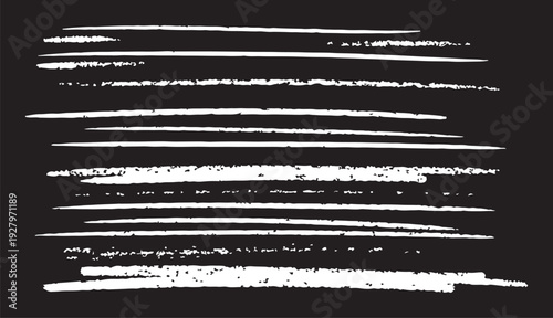 A set of distressed white chalk lines with varied textures and grit, displayed on a dark background for an authentic chalkboard effect.