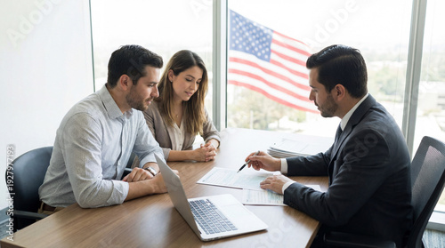 Immigration lawyer reviews visa documents indoors. Couple discusses visa options with attorney, signs forms near USA flag for Citizenship Day outreach, relocation planning, business travel concept
