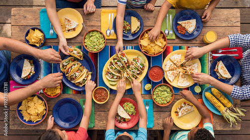 Family eating tacos and Mexican food for Cinco de Mayo celebration