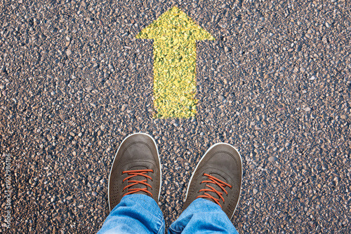Shoes on road with straight arrow showing forward direction