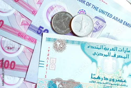 Close-up of United Arab Emirates Currency: AED Banknotes and Dirham Coins Scattered on Surface