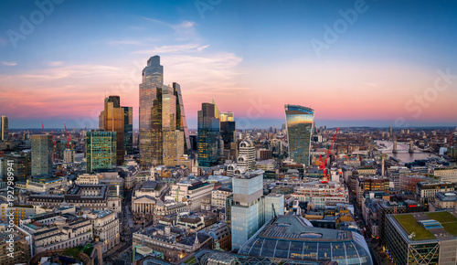 Aerial view of the City of London, UK, skyline from Bank until Tower Bridge with office skyscrapers reflecting the sunlight during sunset