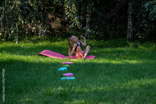 A young gymnast trains outdoors.