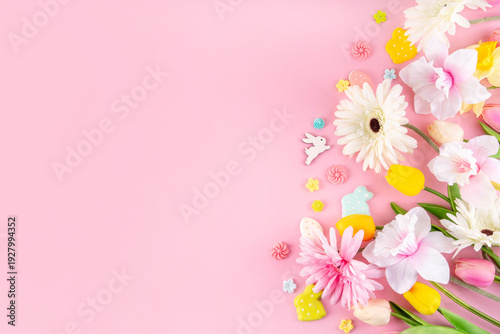 Beautiful spring flowers bouquet with Easter decorations on pink background