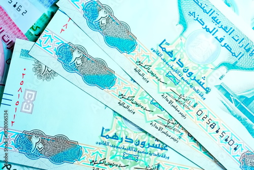 Close-up of United Arab Emirates Currency: AED Banknotes and Dirham Coins Scattered on Surface