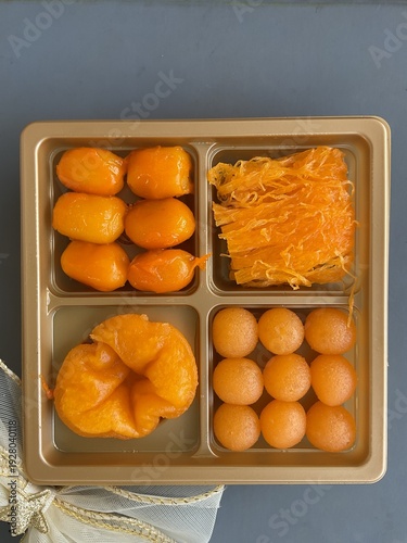 Traditional Thai dessert thong yip and thong you’d in plastic tray