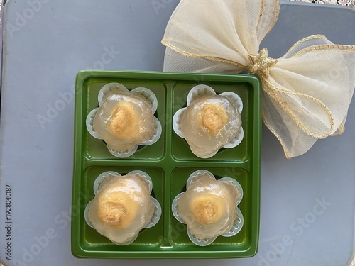 Top view of four traditional Thai khanom tian in green tray