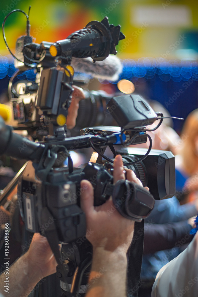 Fototapeta premium Professional Video Camera Operator Filming Live Event with Copy Space for Media Concept