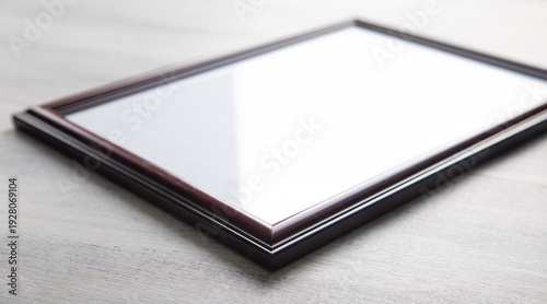 Empty diploma or certificate frame on the table.