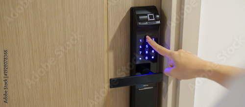 Foto Hand press PIN number for smart digital door lock while open or close the door at home or apartment