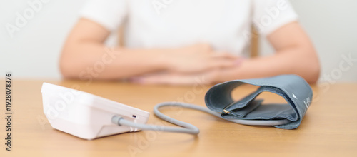 фотографія woman checking Blood pressure by Blood pressure monitor with Cuff