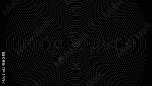 Subtle gray concentric circles on a dark black background, forming an abstract pattern.