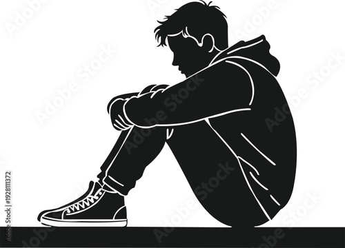 Side view black silhouette of a hooded teenager sitting alone, arms wrapped around legs