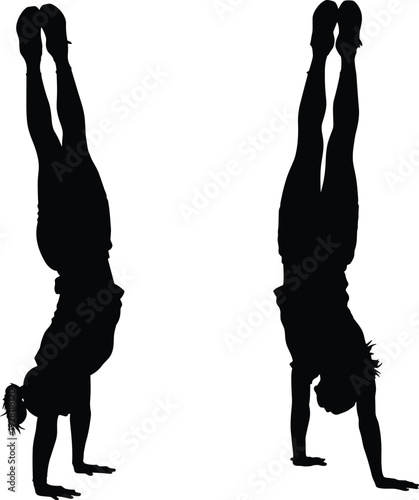 Black silhouettes of two young women performing handstands on white background, fitness and gymnastics concept showing athletic balance, strength, and body control.