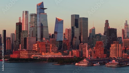 New York City skyline with Midtown West and Hudson Yards skyscrapers at sunset. Aerial view of Chelsea and Hudson River Park piers