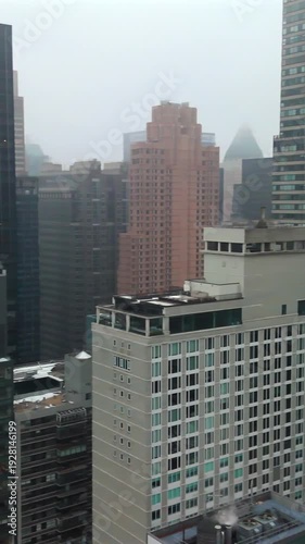 Half sweep drone panorama over Manhattan and Central Park South in winter haze
