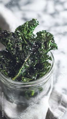 Wallpaper Mural Crunchy dark green kale chips with sea salt crystals in clear glass jar on soft linen cloth against bright blurred marble background, mindful clean eating concept Torontodigital.ca