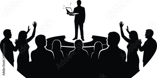 Man on stage giving a presentation or speech to an audience, holding a laptop and gesturing