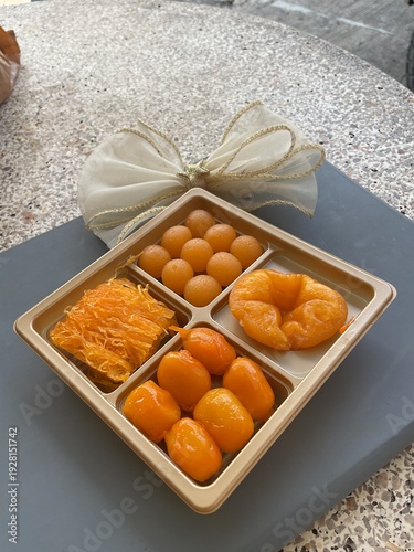 Top view of Thai desert thong yip thong you in four compartments tray