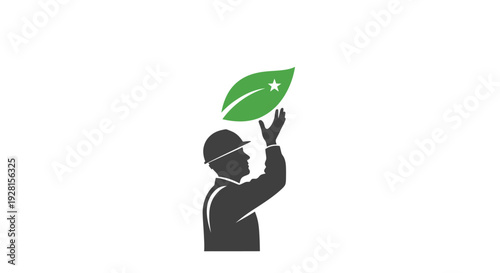 Man holding green leaf up high.