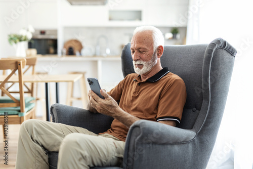 Smile, relax and a senior man with a phone on the sofa for social media, contact or communication. Happy, online and an elderly person on the home armchair with a mobile for an app or typing a chat.