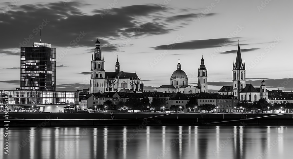 Fototapeta premium Cityscape with historic churches and modern building reflected in water.