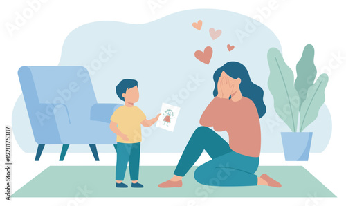Little boy gives his mother a handmade drawing, making her feel emotional and loved as she sits on the floor covering her face with joy in a cozy living room