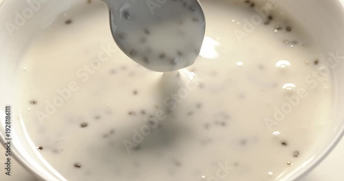 Yogurt with chia is mixed with a spoon and taken.