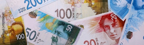 Tableau sur toile Israel shekel money bills pile on table