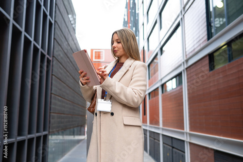 Wallpaper Mural Businesswoman using a digital tablet with an ID badge in a business district Torontodigital.ca