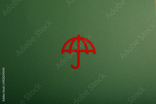 Red umbrella cutout on a gr...
