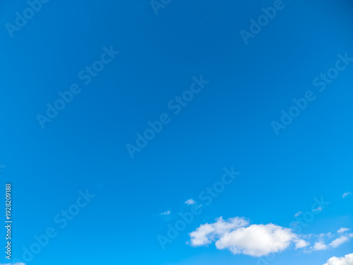 Obraz na płótnie Clear vivid blue sky providing a vast background or copy space, featuring small